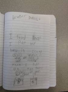 First grade student uses a notebook to make sense of a class model of whale blubber.